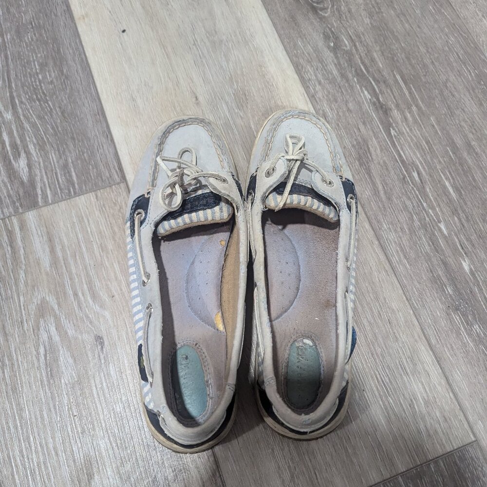 Light blue Sperrys with white stripes on side. Size 7.5 Women's